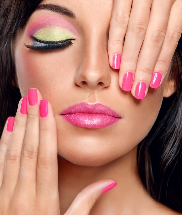 Fashionable make-up and fuchsia color manicure.Nail polish.